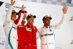 Valtteri Bottas, Mercedes AMG F1, 2nd position, Sebastian Vettel, Ferrari, 1st position, and Lewis Hamilton, Mercedes AMG F1, 3rd position, on the podium with the Ferrari Constructors trophy delegate