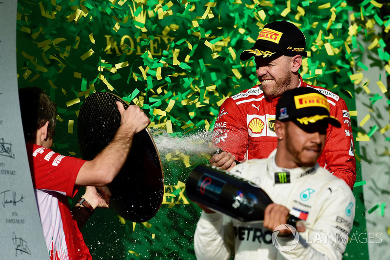 Lewis Hamilton, Mercedes-AMG F1 and Sebastian Vettel, Ferrari celebrate on the podium with the champagne