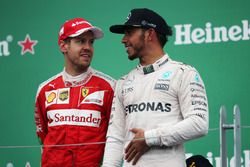 (L to R): Sebastian Vettel, Ferrari with race winner Lewis Hamilton, Mercedes AMG F1 on the podium