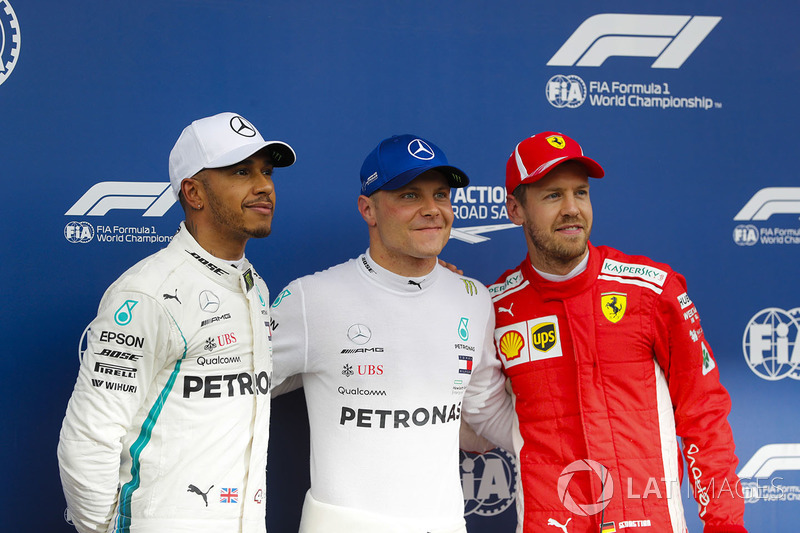 Pole sitter Valtteri Bottas, Mercedes AMG F1, poses with second place Lewis Hamilton, Mercedes AMG F1, and third place Sebastian Vettel, Ferrari