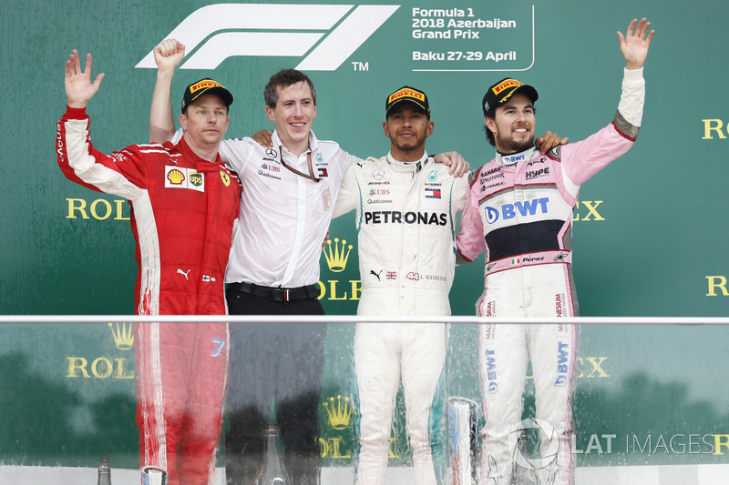 Kimi Raikkonen, Ferrari, 2nd position, the Mercedes Constructors trophy delegate, Lewis Hamilton, Mercedes AMG F1, 1st position, and Sergio Perez, Force India, 3rd position, on the podium