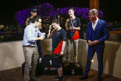 Brendon Leigh celebrates on the podium after winning the E-Sports event