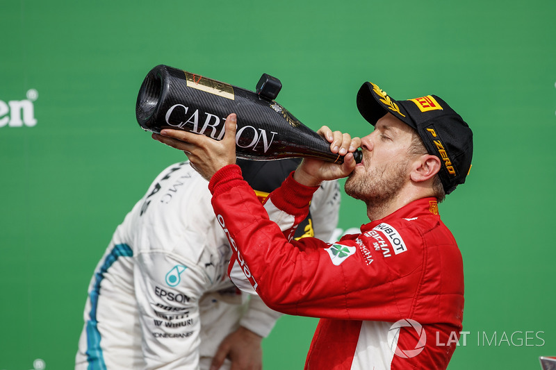 Sebastian Vettel, Ferrari, 1st position, drinks Champagne on the podium