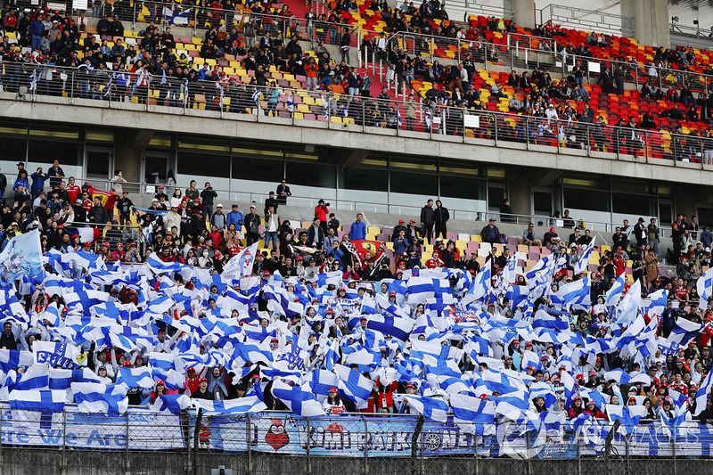 Fans of Kimi Raikkonen, Ferrari, wave Finnish flags