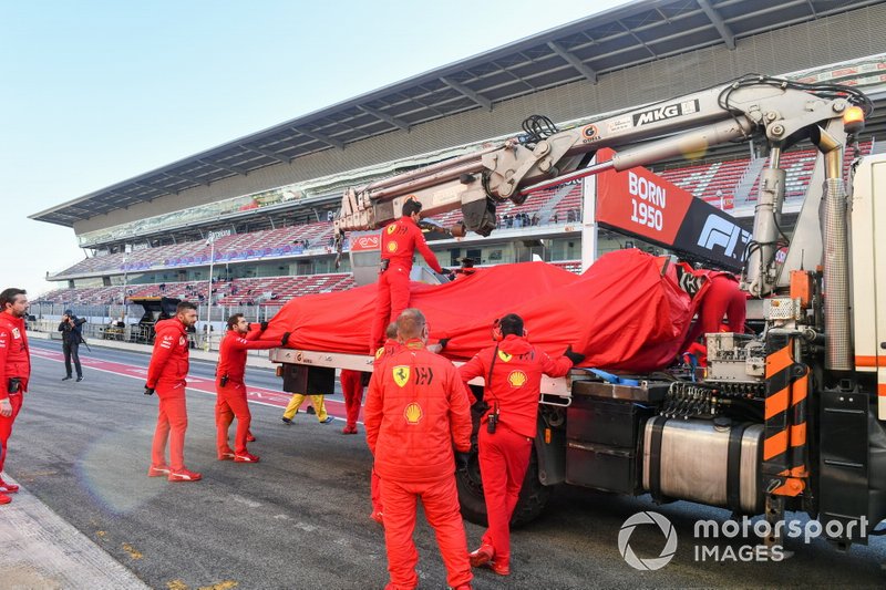 Sebastian Vettel, Ferrari, is lifted back into the garage after stopping on track 