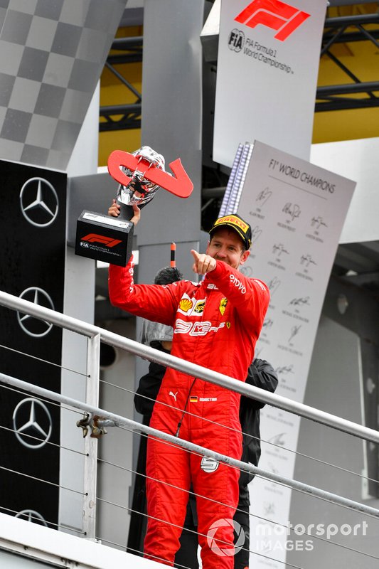 Sebastian Vettel, Ferrari celebrates on the podium with the trophy