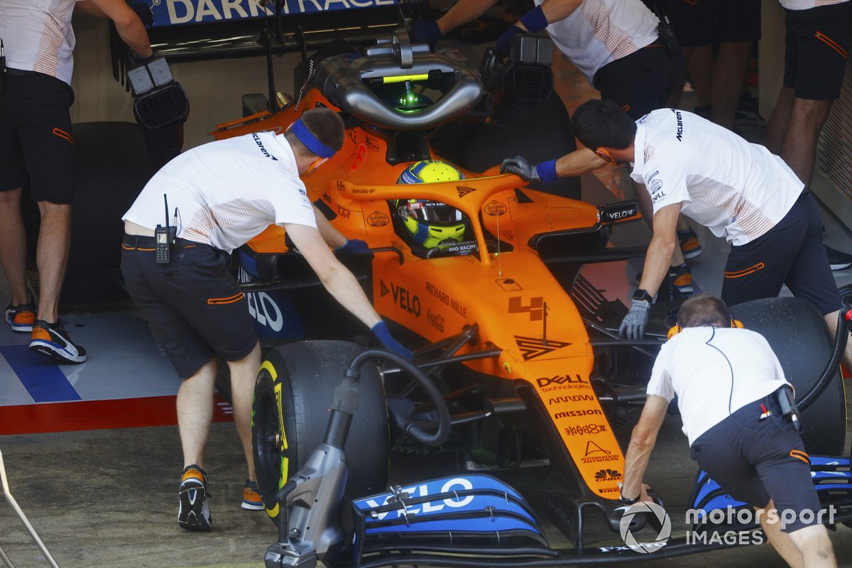 Lando Norris, McLaren MCL35, is returned to the garage