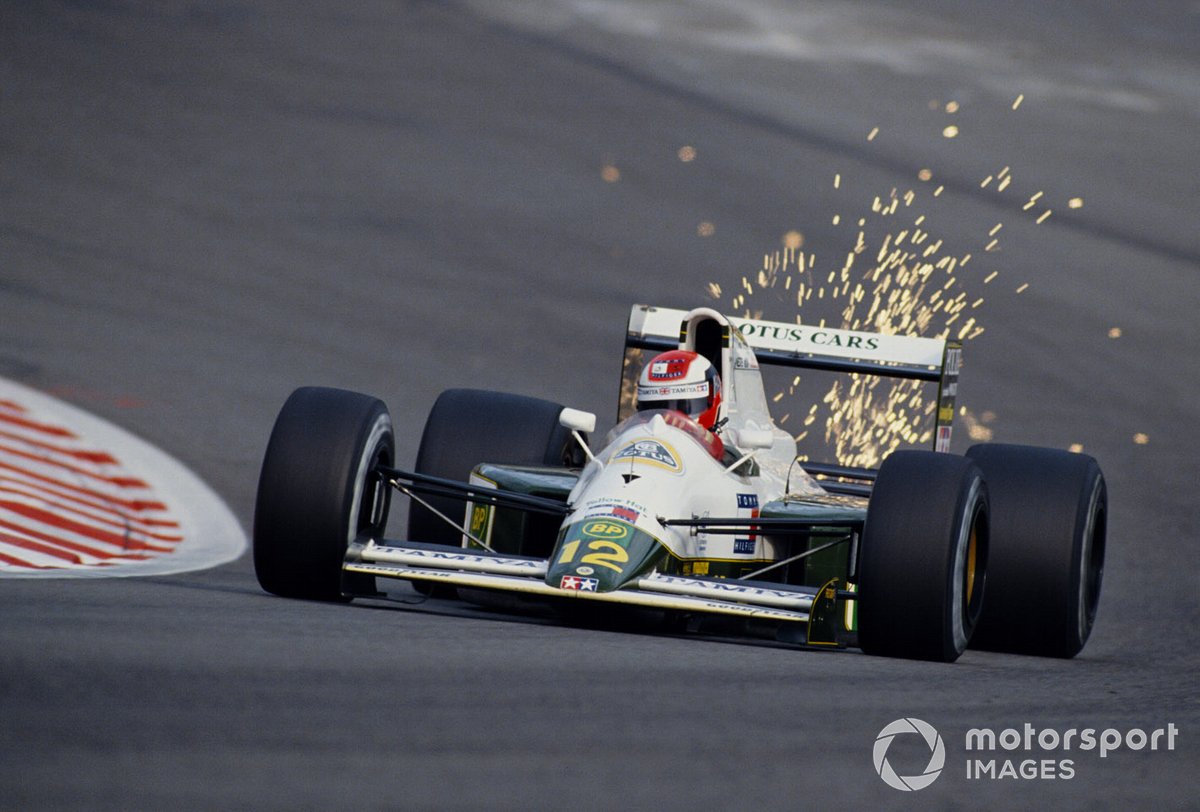 Sparks fly from the underside of Johnny Herbert's Lotus 102B Judd