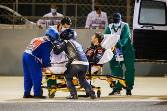 Medical delegates assist Romain Grosjean, Haas F1, after a huge crash on the opening lap