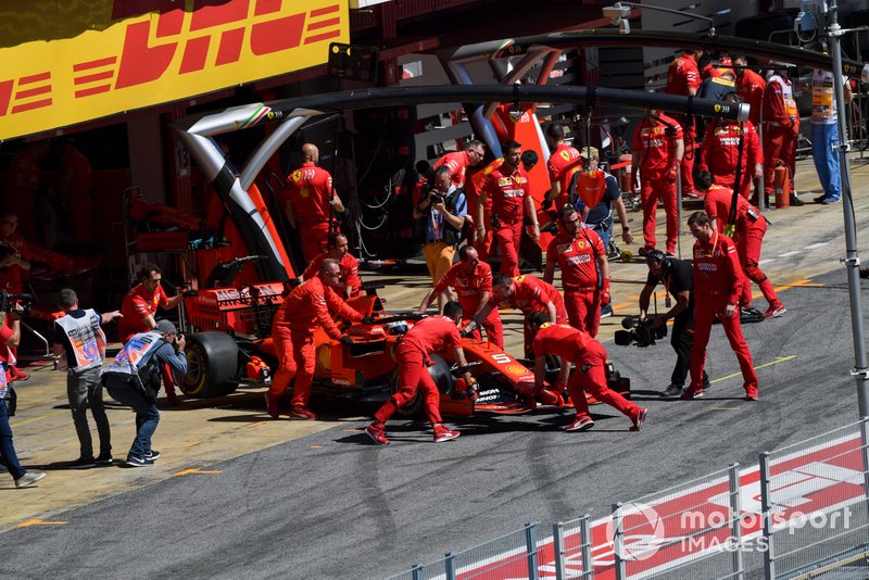 Sebastian Vettel, Ferrari SF90, is returned to the garage