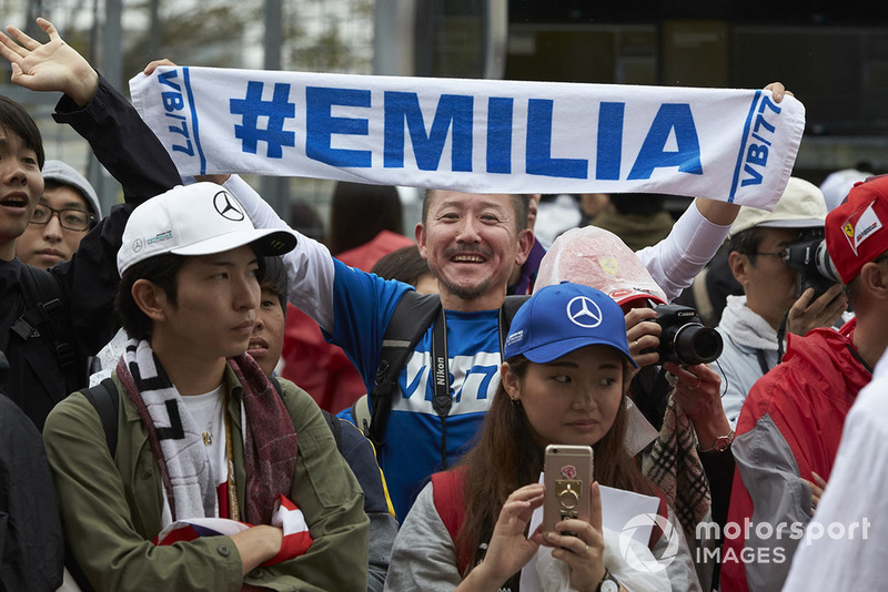 A fan with a banner with Valtteri Bottas' wife Emilia's name