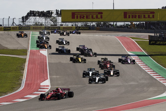 Kimi Raikkonen, Ferrari SF71H, leads Lewis Hamilton, Mercedes AMG F1 W09 EQ Power+, Valtteri Bottas, Mercedes AMG F1 W09 EQ Power+, Daniel Ricciardo, Red Bull Racing RB14, Sebastian Vettel, Ferrari SF71H, and the rest of the field on the opening lap
