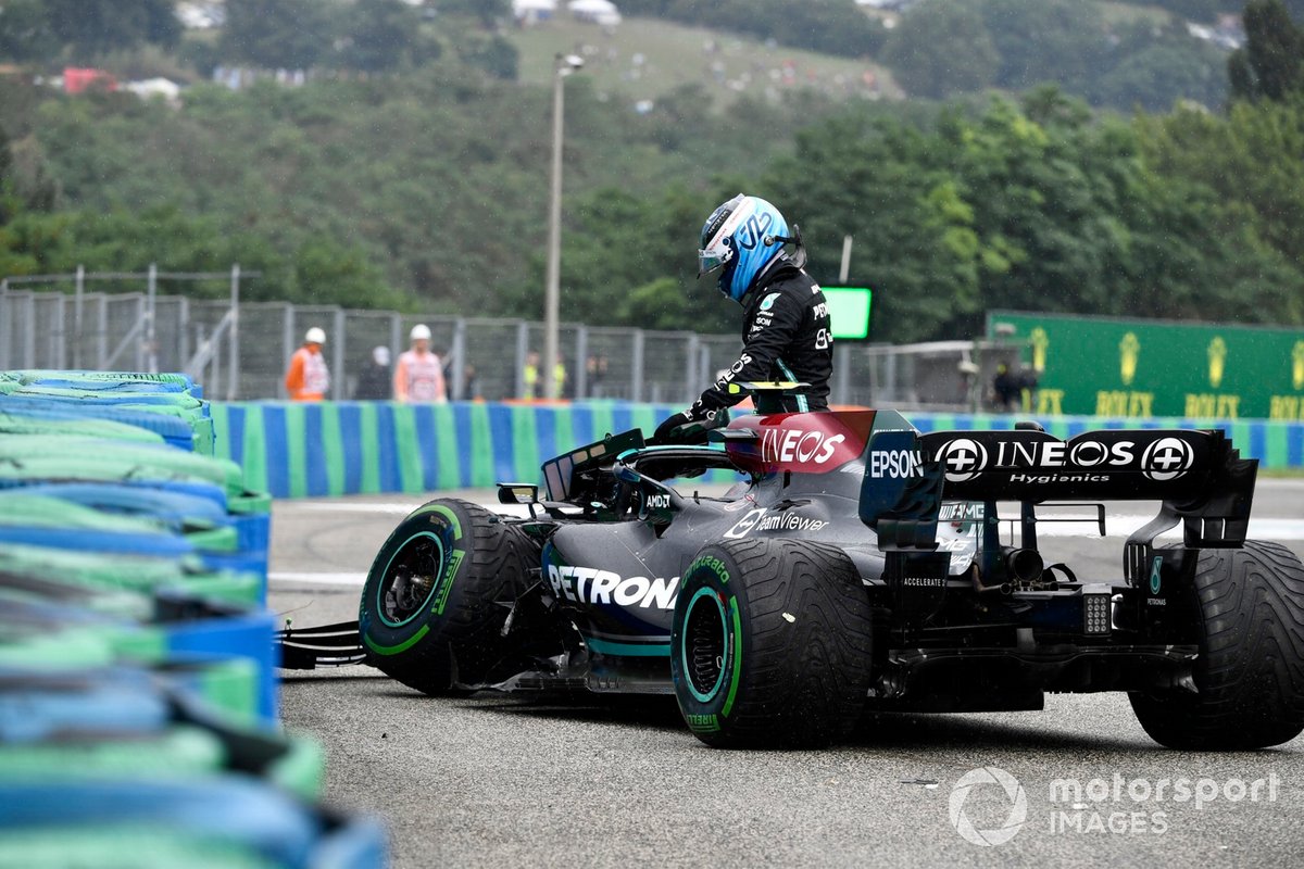 Valtteri Bottas, Mercedes W12, climbs out of his damaged car after crashing out at the start