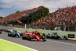 Sebastian Vettel, Ferrari SF70H, Lewis Hamilton, Mercedes AMG F1 W08, lead the field away at the sta