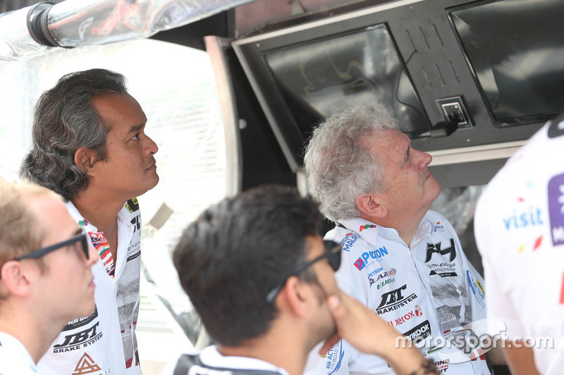 Team watching the race on pit wall