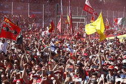 A throng of Ferrari fans invade the circuit after the race