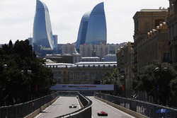 Felipe Massa, Williams FW40, Kimi Raikkonen, Ferrari SF70H, drive down opposing sides of a carriagew
