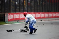 A marshall collects debris from the Sauber C35 of Marcus Ericsson, Sauber F1 Team