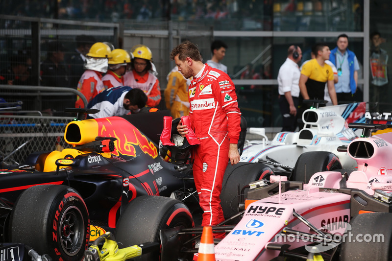 Sebastian Vettel, Ferrari, inspects the car of Daniel Ricciardo, Red Bull Racing RB13, in Parc Ferme