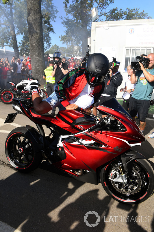 Lewis Hamilton, Mercedes AMG F1 arrives at the track on his motorbike