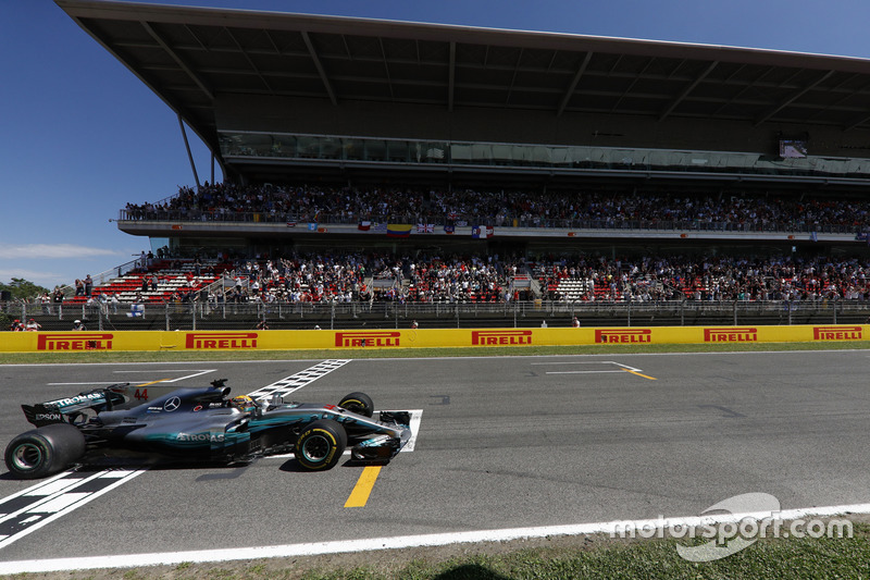 Lewis Hamilton, Mercedes AMG F1 W08, crosses the line to win the race