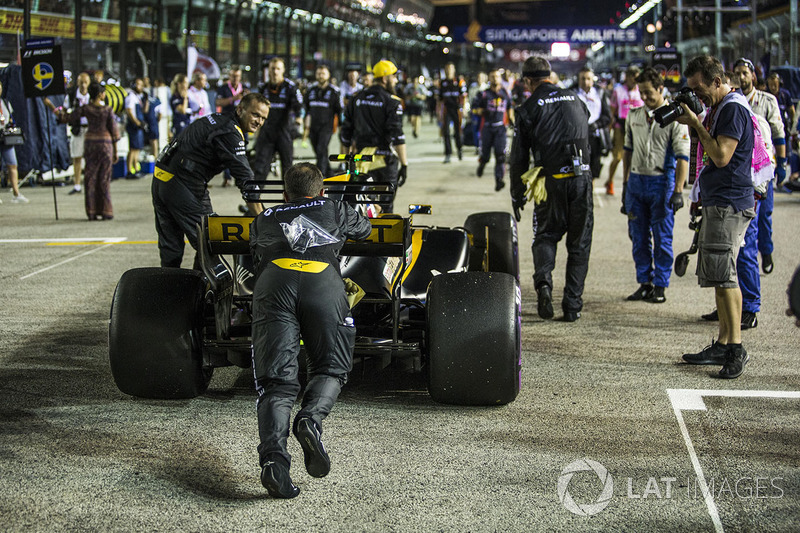 The car of Jolyon Palmer, Renault Sport F1 Team RS17 is pushed by mechanics