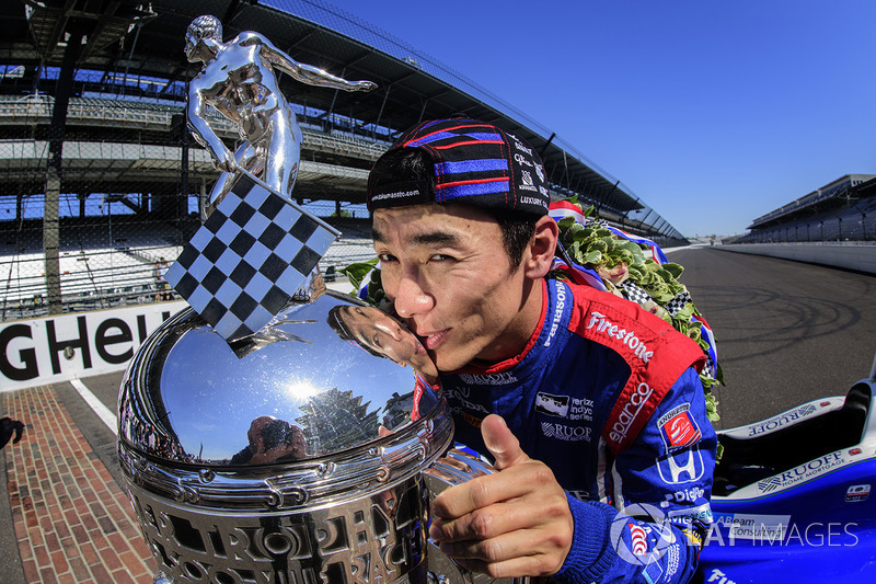 Takuma Sato, Andretti Autosport Honda celebrates his win of the Indy 500 by kissing the Borg-Warner Trophy on the yard of bricks