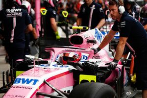 Esteban Ocon, Racing Point Force India VJM11, is moved in the pit lane by engineers