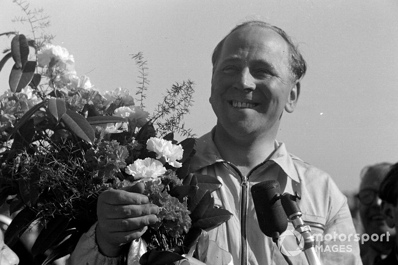 Reg Parnell receives a bouquet of flowers after finishing third