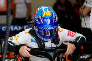 Fernando Alonso, McLaren, lowers himself into his seat