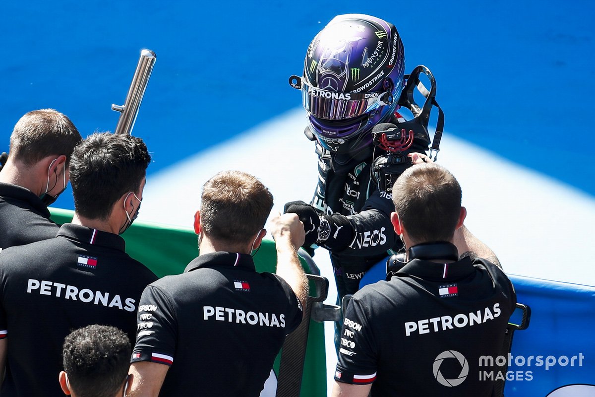 Lewis Hamilton, Mercedes, celebrates in Parc Ferme with his team after securing a record 100th pole in F1