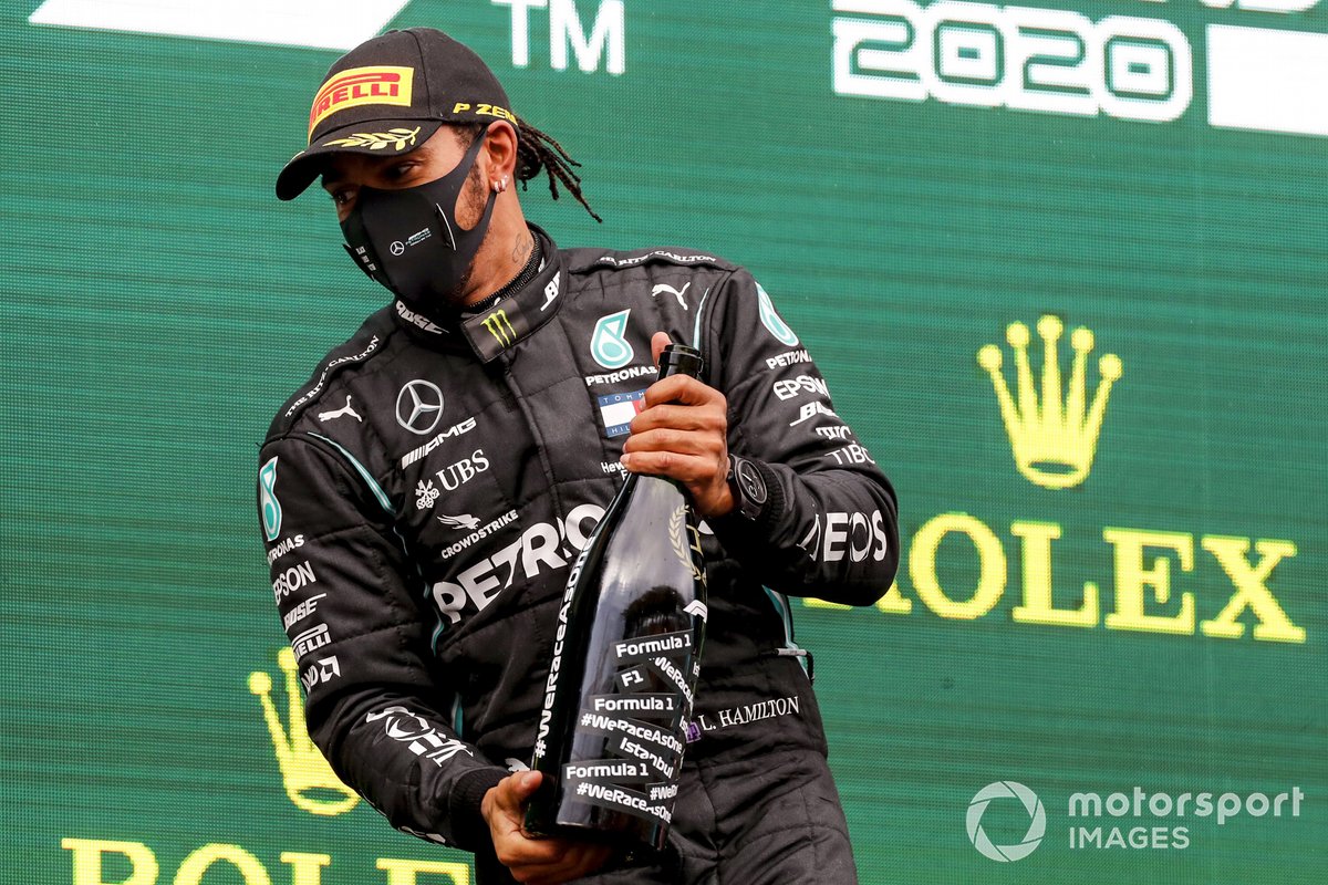 Lewis Hamilton, Mercedes-AMG F1, climbs on the podium after winning the race, to take his 7th World Championship title