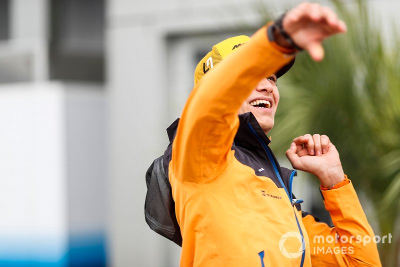 Lando Norris, McLaren, throws a rugby ball