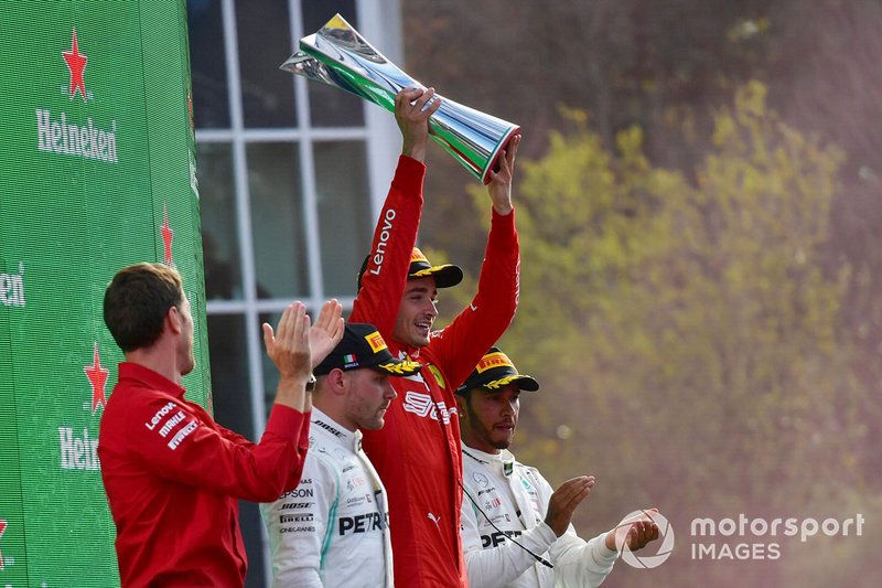 Charles Leclerc, Ferrari, 1st position, lifts his trophy