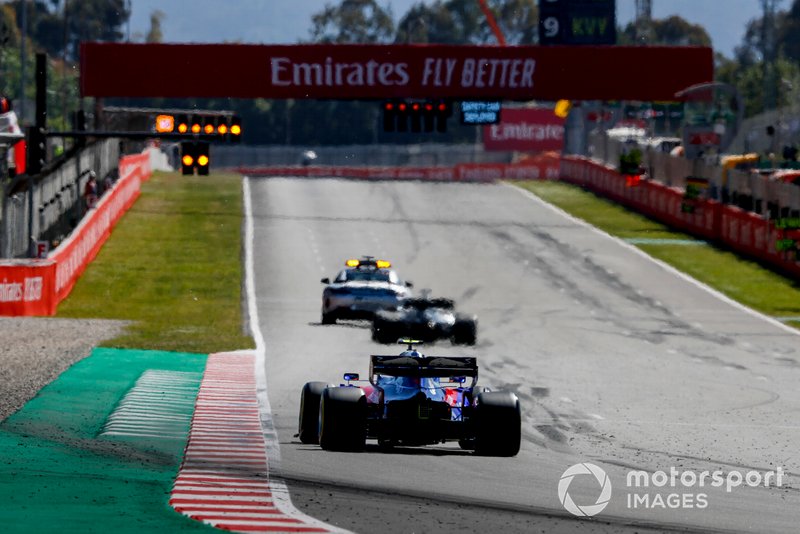 The Safety Car leads Lewis Hamilton, Mercedes AMG F1 W10, and Alexander Albon, Toro Rosso STR14
