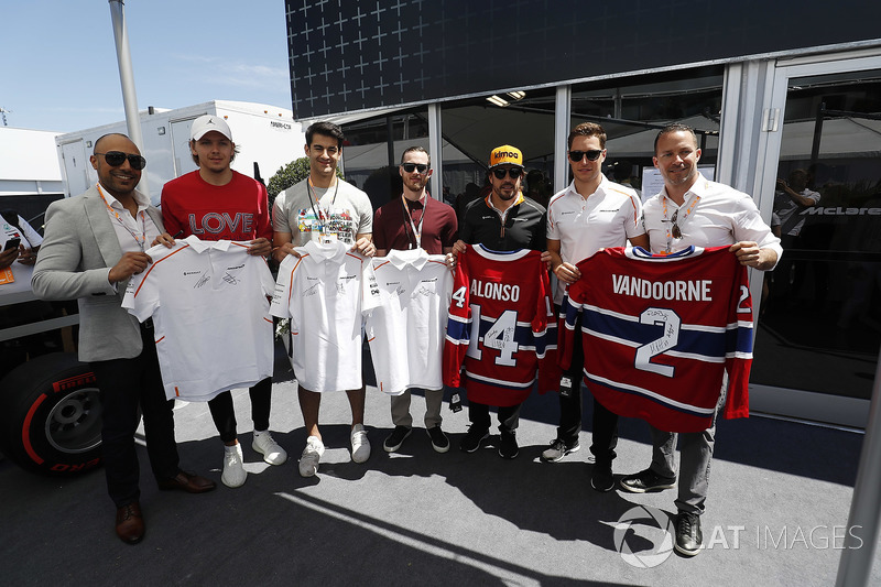 Fernando Alonso, McLaren, and Stoffel Vandoorne, McLaren, swap shirts with hockey players, including