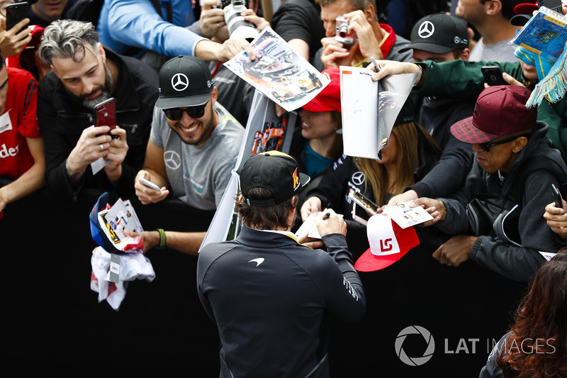 Fernando Alonso, McLaren, signs autographs for fans