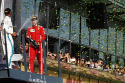 Lewis Hamilton, Mercedes AMG F1, 2nd position, and Sebastian Vettel, Ferrari, 1st position, celebrat