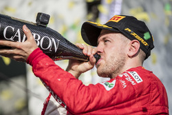 Sebastian Vettel, Ferrari, 1st position, celebrates on the podium with Champagne