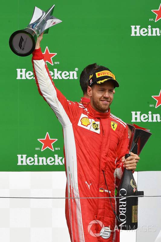 Race winner Sebastian Vettel, Ferrari celebrates on the podium with the trophy