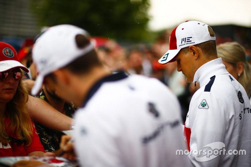 Charles Leclerc, Sauber, and Marcus Ericsson, Sauber, sign autographs for fans