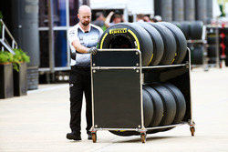A McLaren mechanic with Pirelli tyres