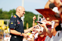 Adrian Newey, Red Bull Racing Chief Technical Officer signs autographs for fans
