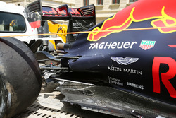 The damaged Red Bull Racing RB12 of Daniel Ricciardo, is recovered back to the pits on the back of a truck