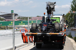 The McLaren MP4-31 of race retiree Fernando Alonso, McLaren is recovered back to the pits on the bac