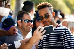 Lewis Hamilton, Mercedes AMG F1, takes a selfie with a fan