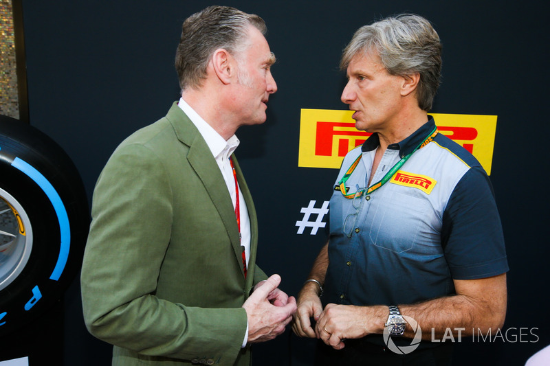 Sean Bratches, Managing Director of Commercial Operations, Formula One Group talks to a Pirelli representative