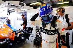 Fernando Alonso, McLaren, puts on his helmet in the garage