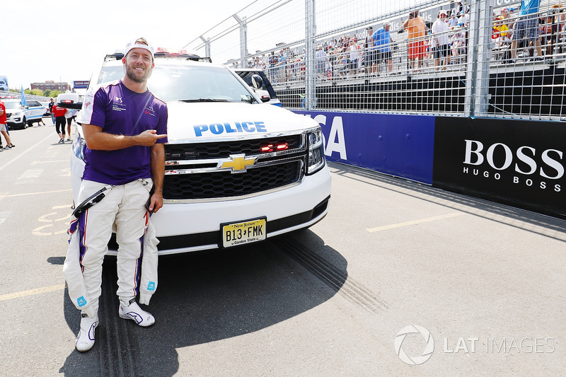 Sam Bird, DS Virgin Racing, poses for a picture with a police vehicle