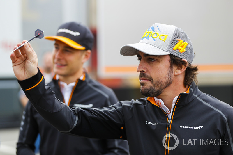 Stoffel Vandoorne, McLaren, and Fernando Alonso, McLaren, play darts